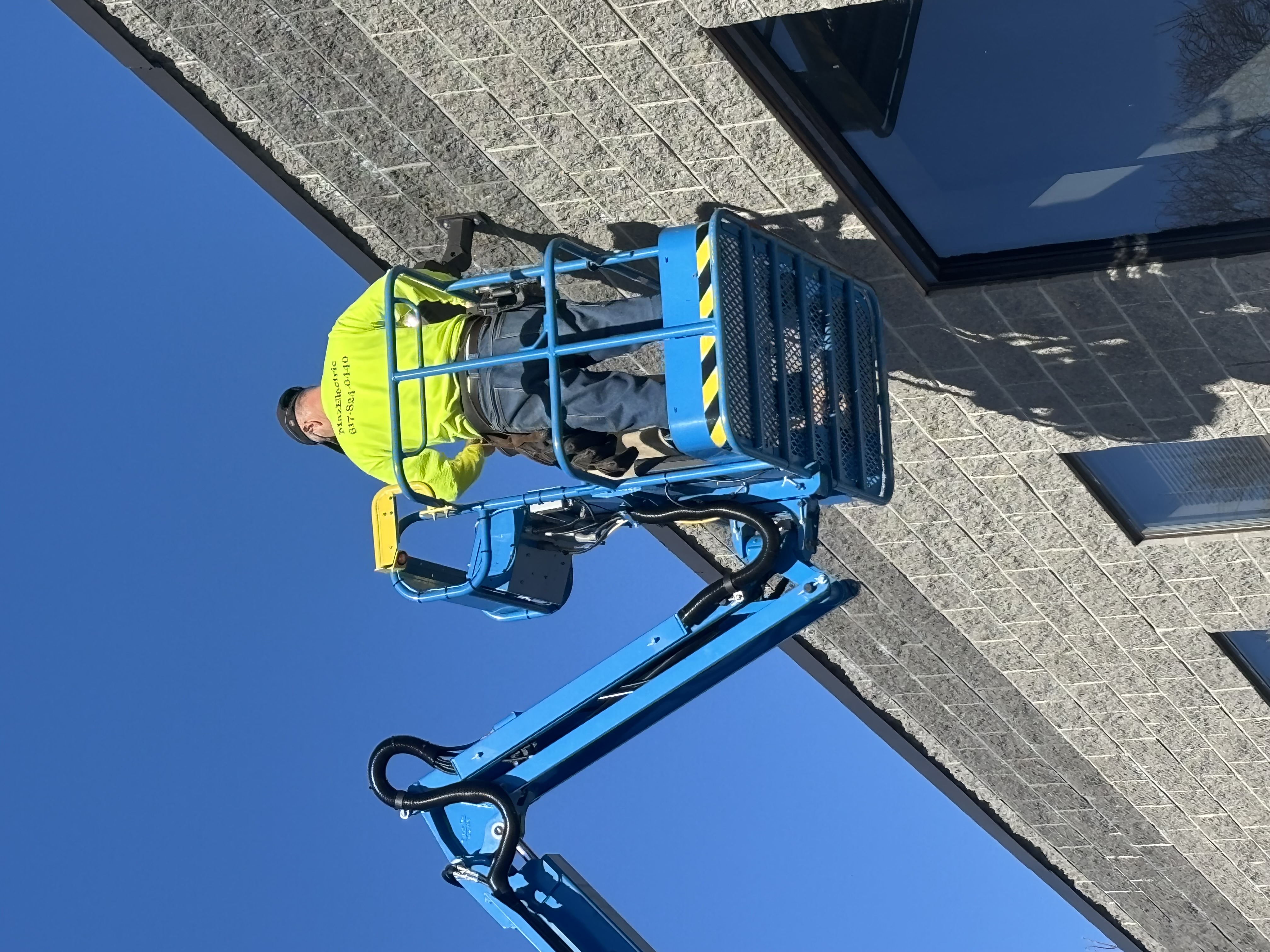Car dealership new light installation on boom lift