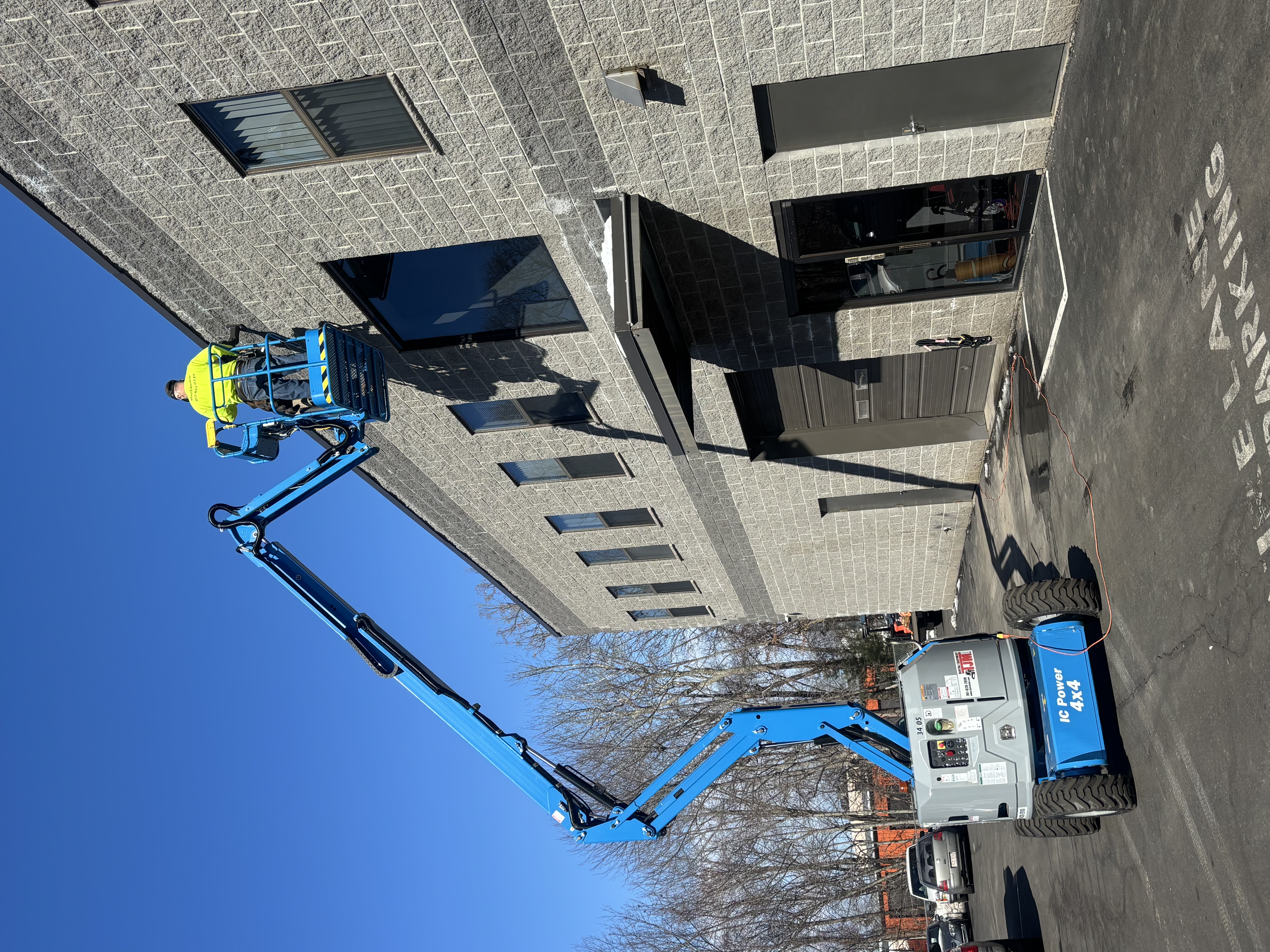 Car dealership exterior light install with boom lift