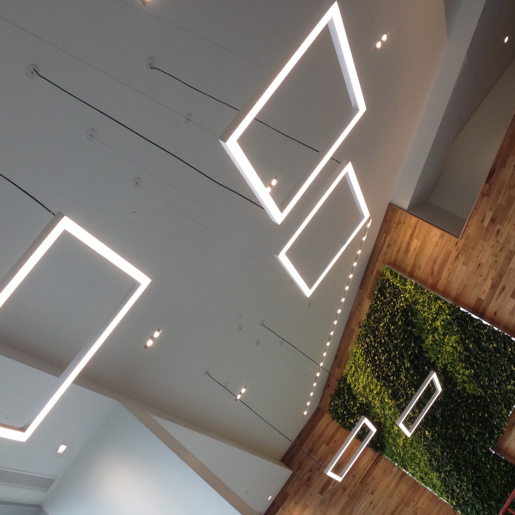 Custom geometric LED frame lighting in commercial lobby